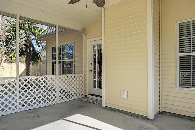 property entrance with ceiling fan and a patio area