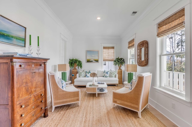 sitting room with crown molding and light hardwood / wood-style floors