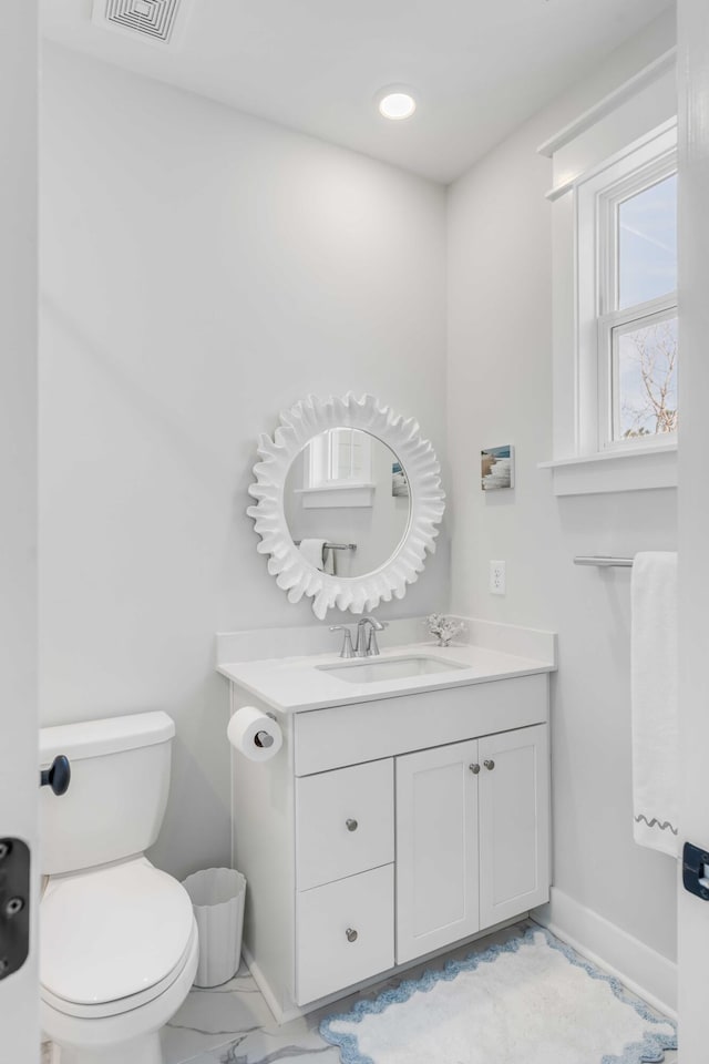 bathroom with toilet and vanity