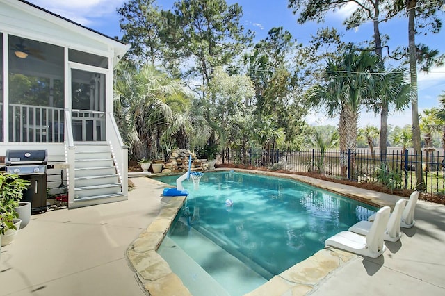 view of pool with a sunroom, a fenced backyard, a patio, and area for grilling