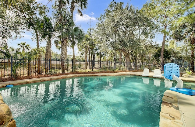 view of swimming pool with fence and a fenced in pool