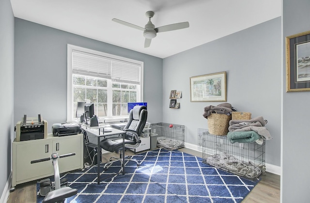 office area with ceiling fan, baseboards, and wood finished floors