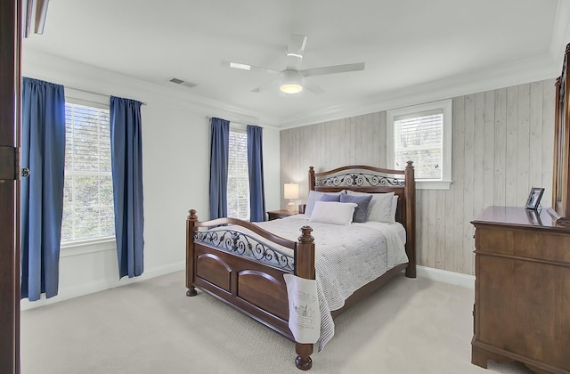 carpeted bedroom featuring visible vents, ceiling fan, and multiple windows