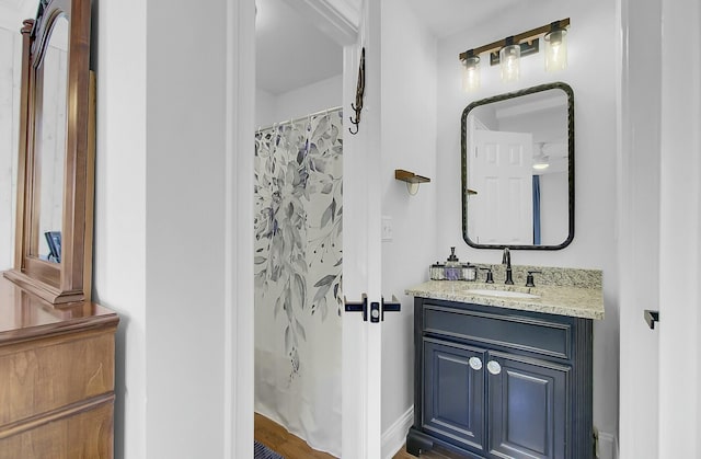 bathroom with a shower with curtain and vanity