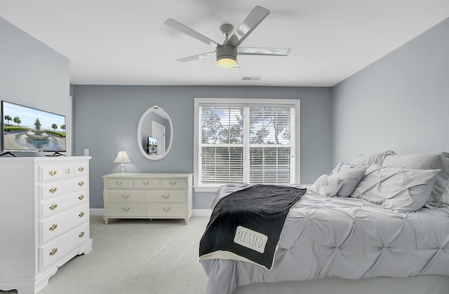 bedroom featuring a ceiling fan, light colored carpet, and visible vents