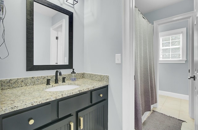 full bathroom with tile patterned flooring, baseboards, and vanity