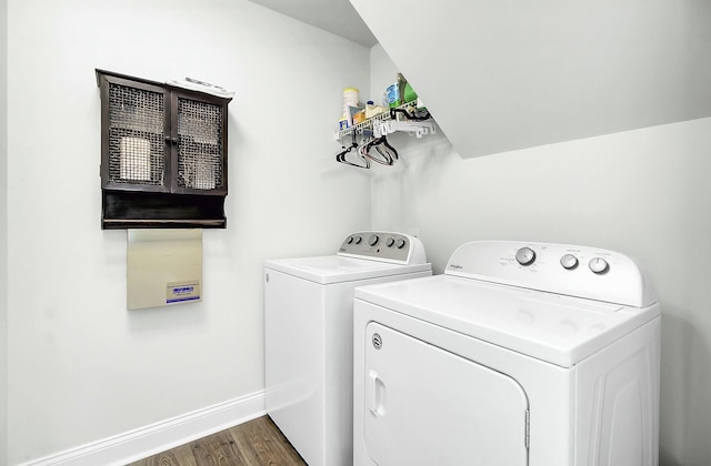 laundry room with laundry area, baseboards, dark wood finished floors, and washing machine and clothes dryer