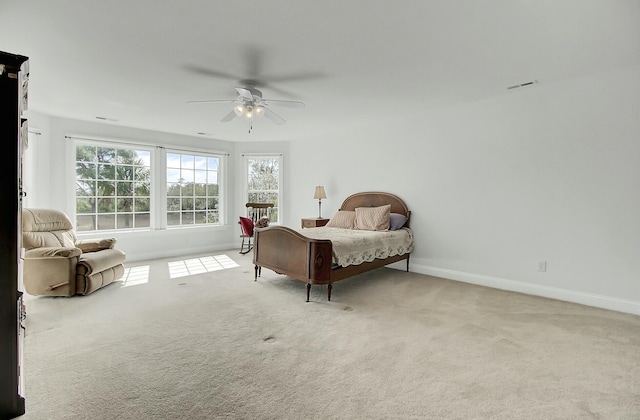 bedroom with carpet flooring, ceiling fan, visible vents, and baseboards