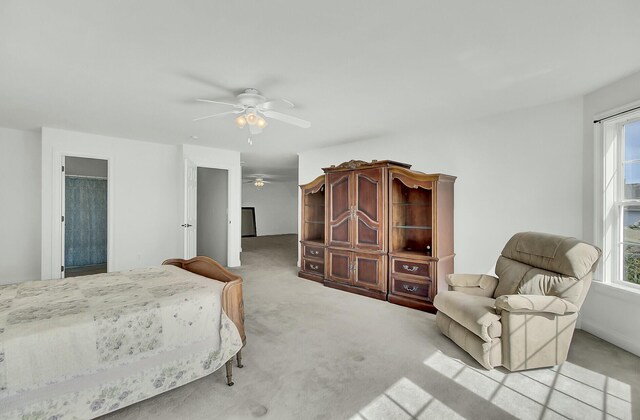 bedroom featuring light carpet and ceiling fan