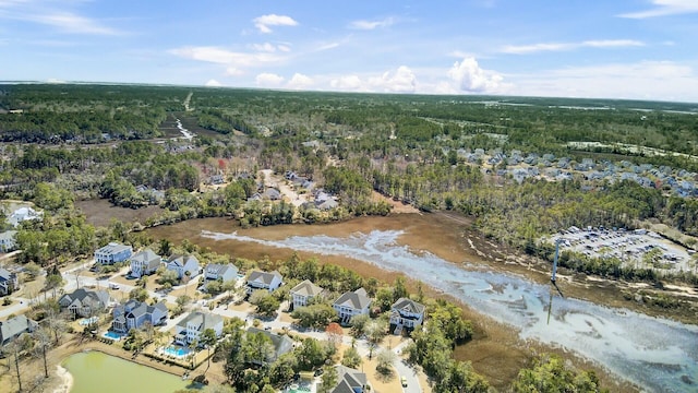 drone / aerial view with a water view and a view of trees