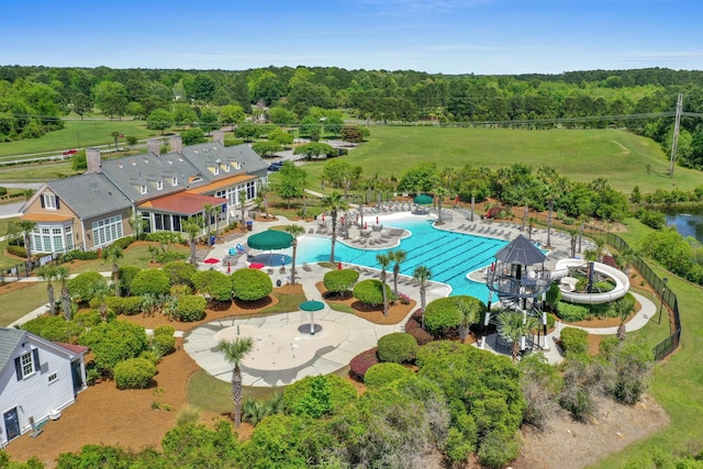 bird's eye view with a wooded view