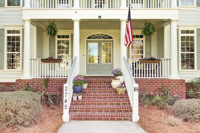 doorway to property featuring a porch and a balcony