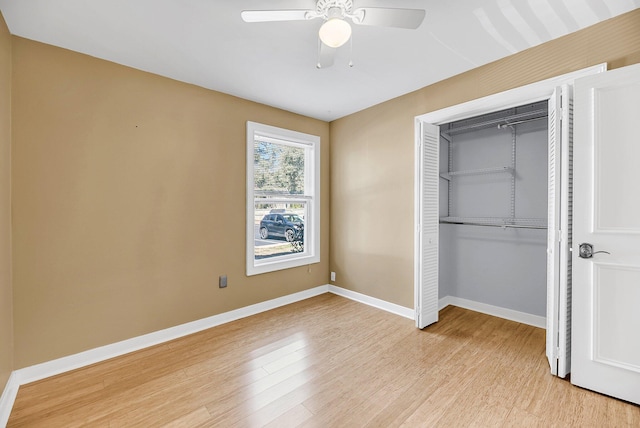 unfurnished bedroom featuring light wood-type flooring, a closet, ceiling fan, and baseboards