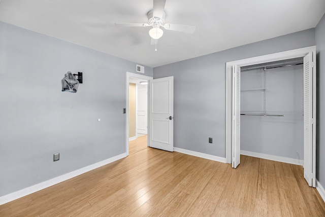 unfurnished bedroom with baseboards, a closet, a ceiling fan, and light wood-style floors