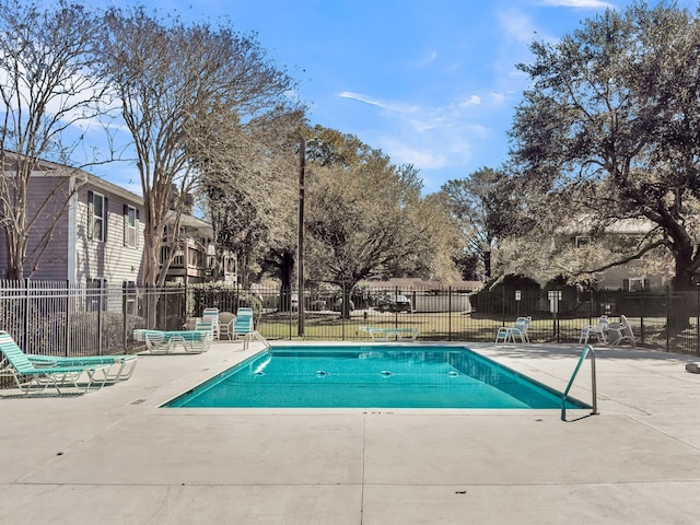 pool featuring fence and a patio