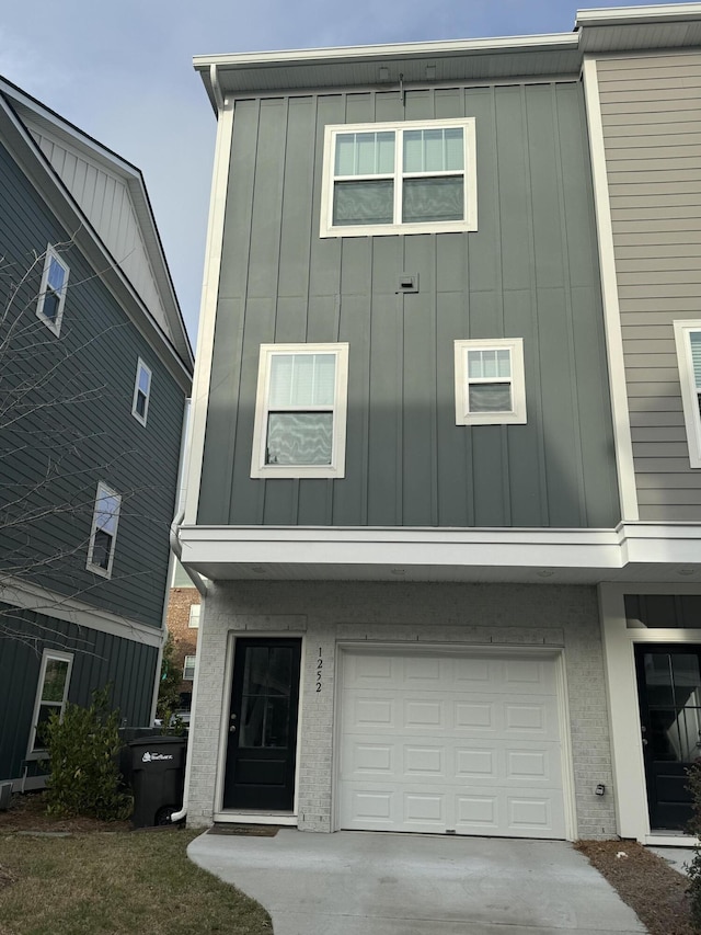 view of front of house featuring an attached garage, board and batten siding, and concrete driveway