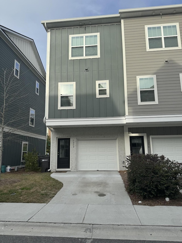 view of front of property with an attached garage, board and batten siding, and concrete driveway