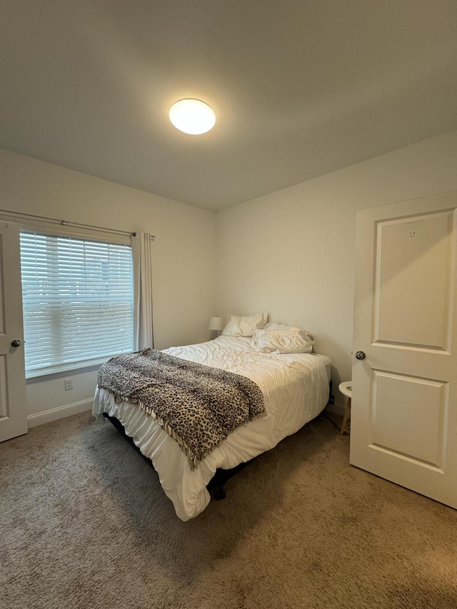 carpeted bedroom with baseboards