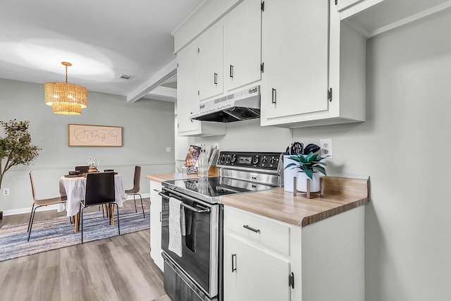 kitchen featuring visible vents, under cabinet range hood, white cabinetry, light wood finished floors, and stainless steel electric range oven