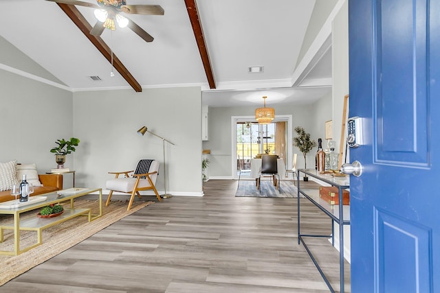 foyer featuring visible vents, baseboards, ceiling fan, lofted ceiling with beams, and wood finished floors