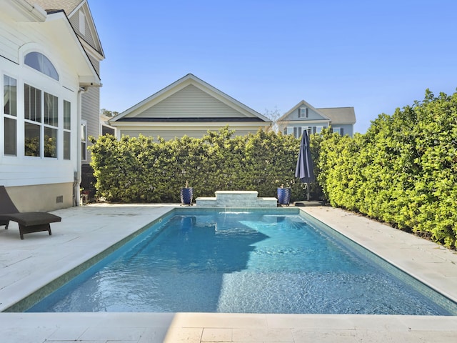 view of swimming pool with a patio and a fenced in pool