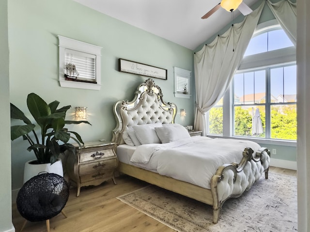 bedroom featuring ceiling fan, lofted ceiling, and wood finished floors