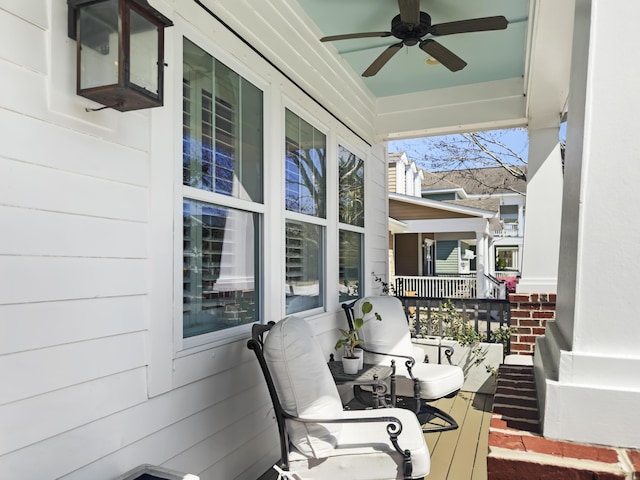 wooden terrace with covered porch and ceiling fan