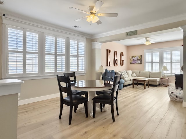 dining space with visible vents, crown molding, baseboards, light wood-style flooring, and a ceiling fan