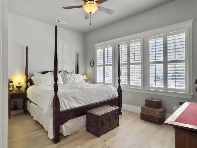 bedroom with visible vents, baseboards, light wood-style floors, and a ceiling fan