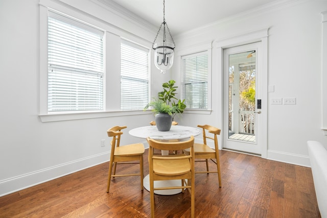 dining area featuring ornamental molding and hardwood / wood-style floors