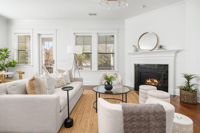 living room featuring wood-type flooring and crown molding