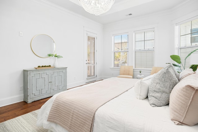 bedroom with ornamental molding, a chandelier, hardwood / wood-style floors, and access to outside