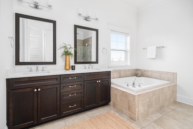 bathroom with tile patterned floors, ornamental molding, shower with separate bathtub, and vanity