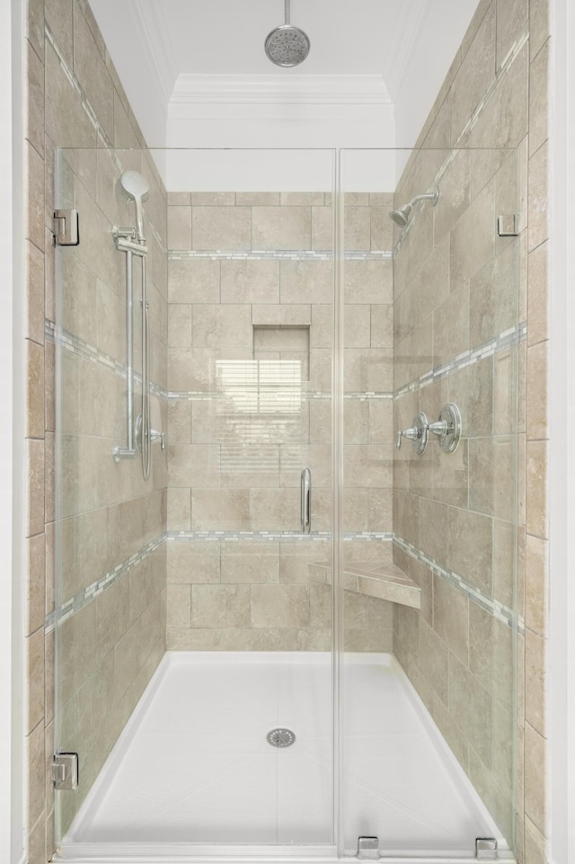 bathroom with an enclosed shower and ornamental molding