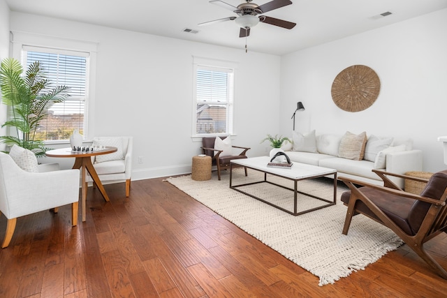 living room with dark wood-type flooring and ceiling fan