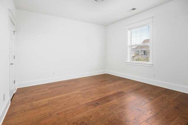 empty room with hardwood / wood-style floors