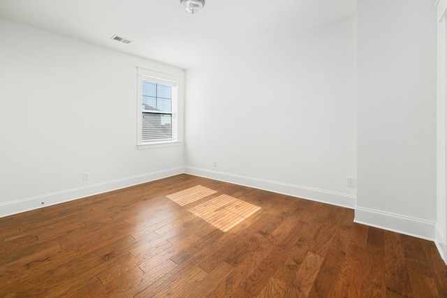 spare room featuring hardwood / wood-style floors