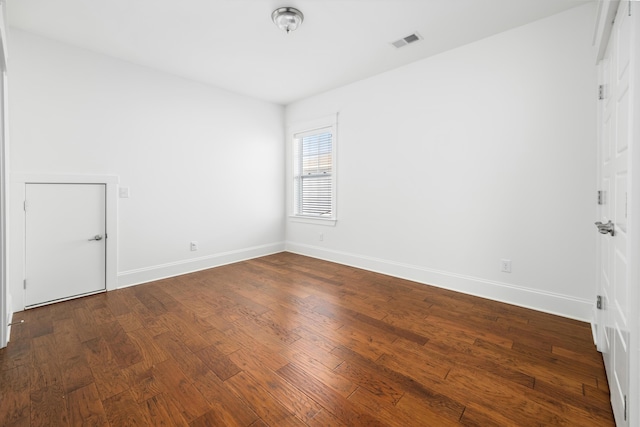 spare room featuring wood-type flooring