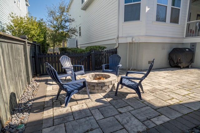 view of patio / terrace with grilling area and a fire pit