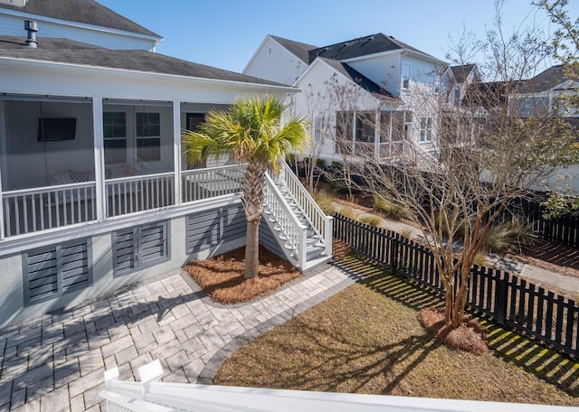 back of property featuring a sunroom