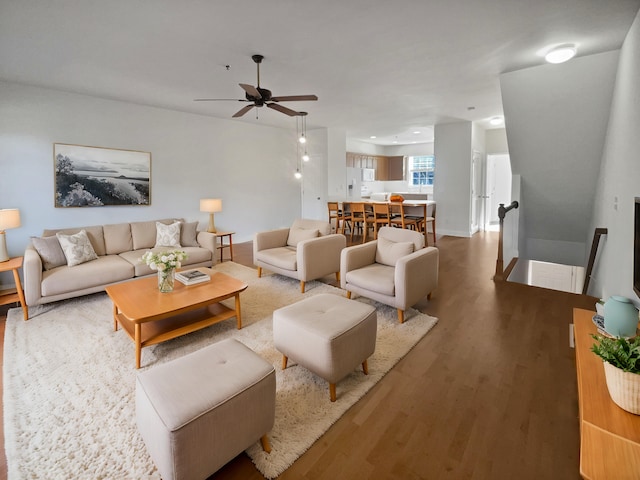 living room with ceiling fan and wood-type flooring