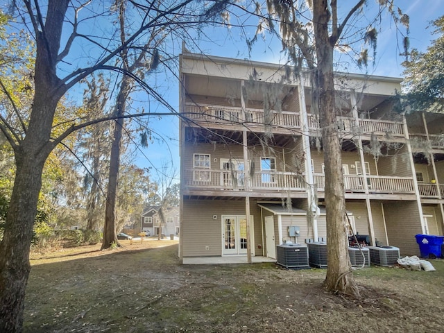 back of property with a patio area and central AC