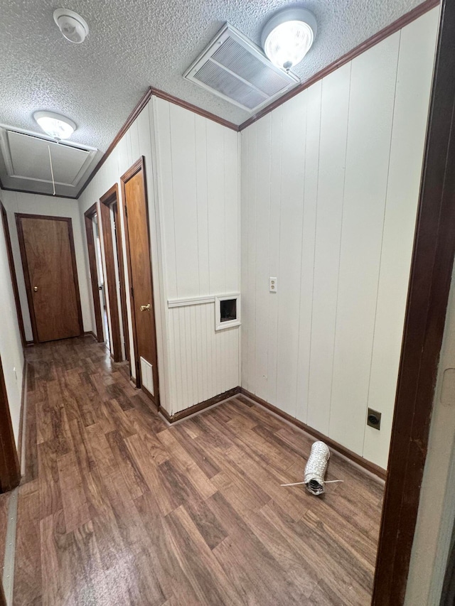 washroom with wood-type flooring and a textured ceiling