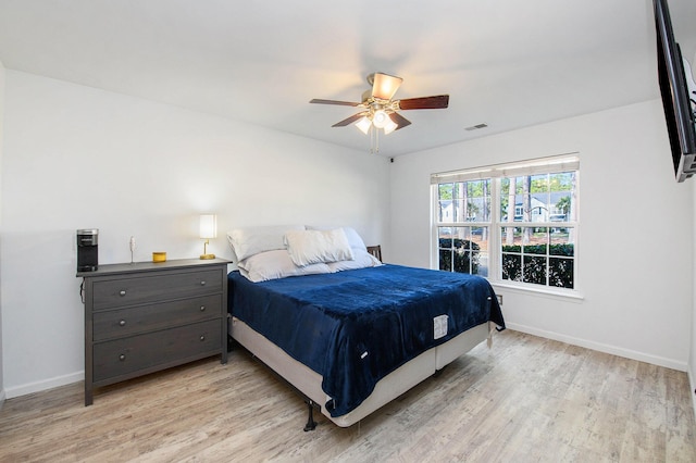 bedroom with ceiling fan and light hardwood / wood-style flooring