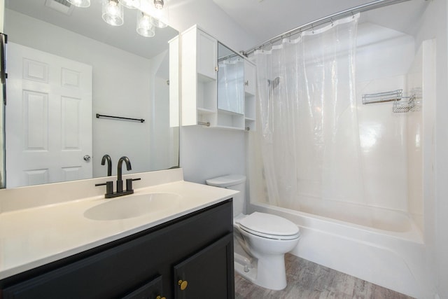 full bathroom featuring shower / tub combo with curtain, hardwood / wood-style floors, vanity, and toilet