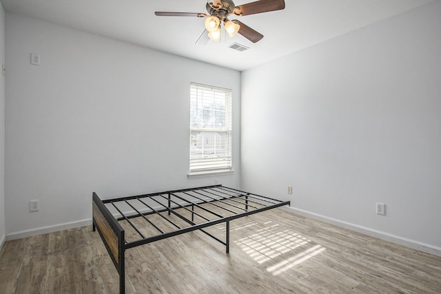 unfurnished bedroom with ceiling fan and hardwood / wood-style floors