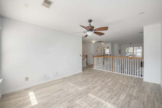 spare room featuring ceiling fan and light hardwood / wood-style flooring