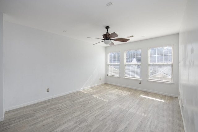 spare room with ceiling fan and light wood-type flooring