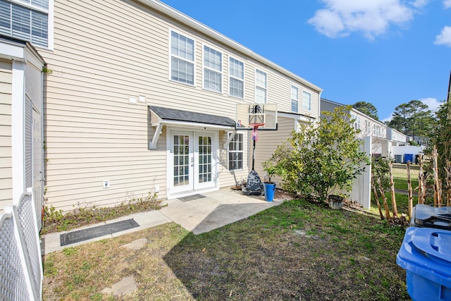 back of property featuring a patio, a yard, and french doors