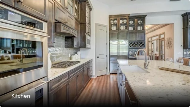 629 Marsh Cove Cir, Summerville, SC 29486 - kitchen with stainless steel appliances, decorative backsplash, light stone countertops, and glass insert cabinets